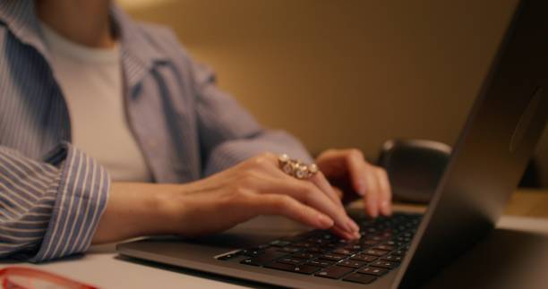 istock A woman uses a laptop at home 2196721436