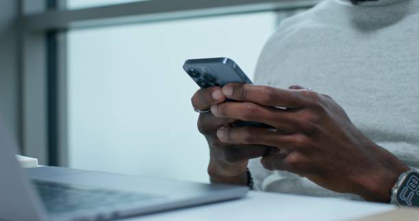 istock A man uses a mobile phone indoors 2196722604