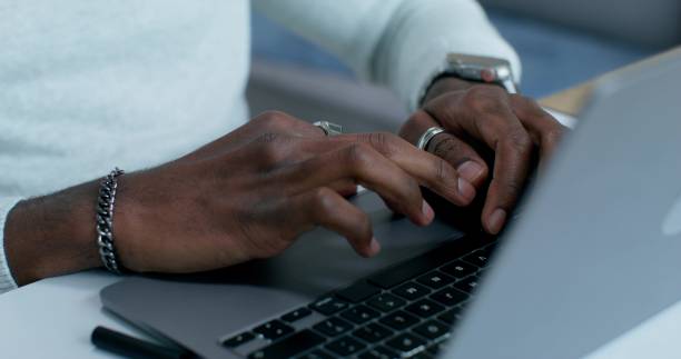 istock A man uses a laptop at home 2196722696