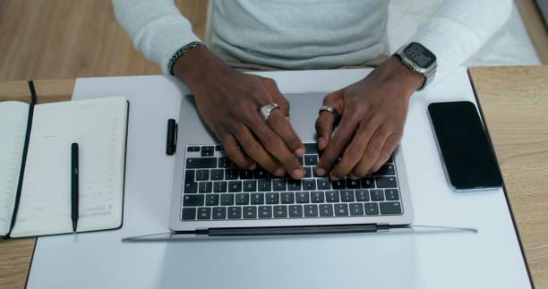 istock A man uses a laptop at home 2196722904