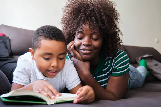 istock Mother and Son Enjoying Reading Together on Couch 2196725575