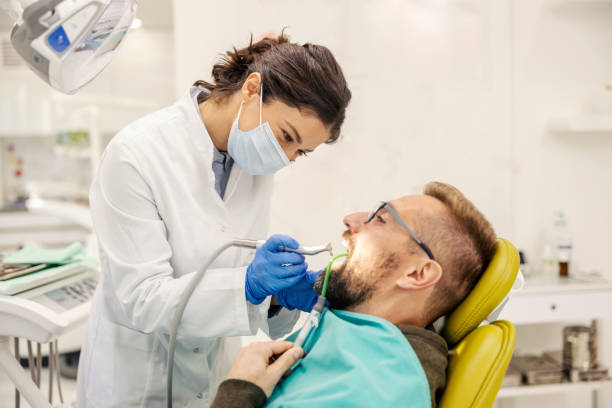 istock Dentist drilling patient's tooth and removing cavity at dentist office. 2196725628