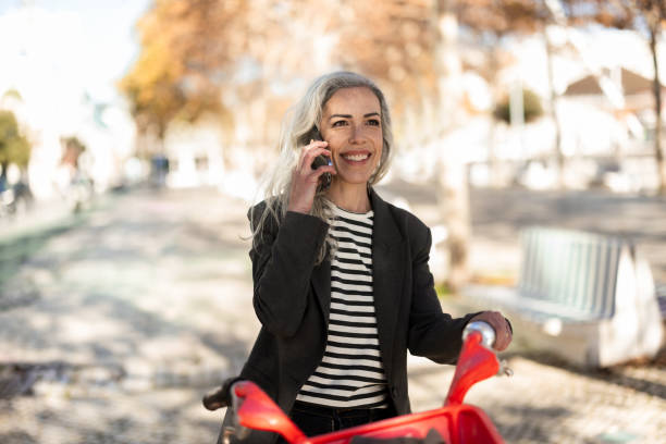 istock Woman talking on the phone while commuting on a bike 2196726882