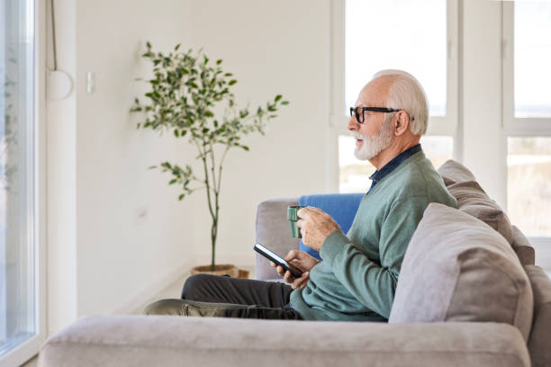 istock Cheerful Man Sipping Coffee and Browsing His Smartphone 2196730356