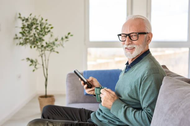 istock Mature Man Enjoying Coffee and His Smartphone at Home 2196730357