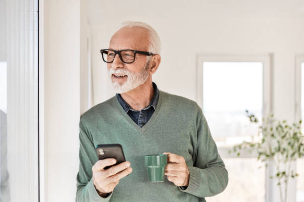 istock Man at Home with Coffee and His Smartphone 2196730401