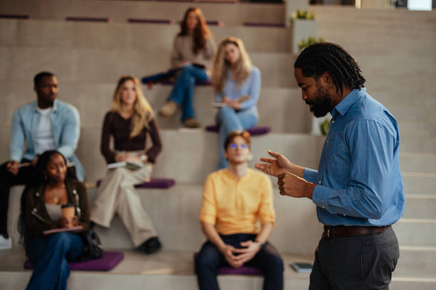 istock University professor giving lesson to students in modern auditorium 2196730425