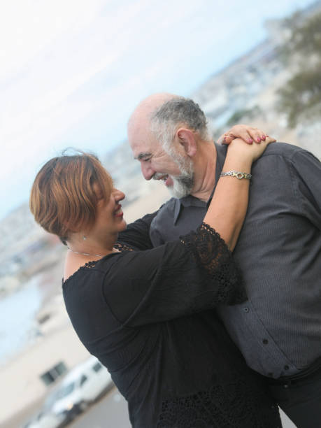 istock cheerful mature couple hugging and looking at each other 2196731639