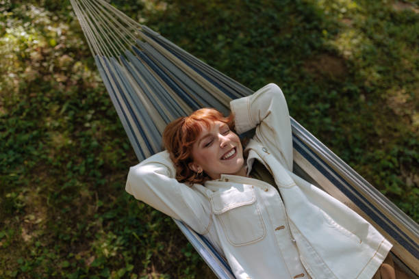 istock Redhead girl relaxing in the hammock 2196734459