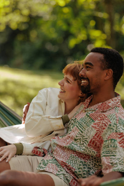 istock Couple relaxing in a hammock outdoors 2196734468