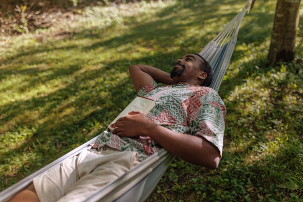 istock Man lying in a hammock and daydreaming 2196734485