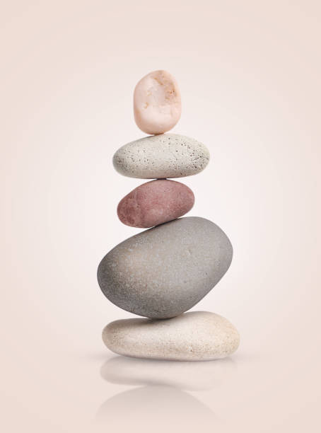istock tower of smooth pebbles on a light beige background. 2196735757