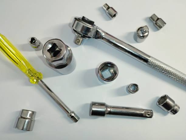 istock On a white background, scattered school tools, namely a screwdriver and a wrench with interchangeable nozzles of different sizes. 2196736553