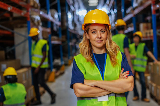 istock Blonde Female warehouse worker smiling while posing for a photo 2196740879