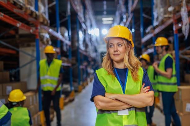 istock Confident female warehouse worker in safety gear 2196740890