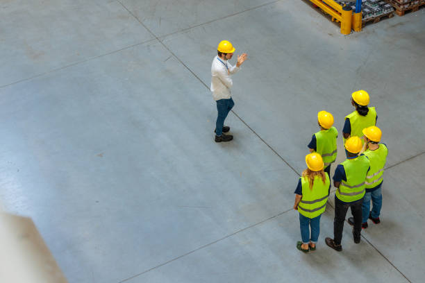 istock Warehouse manager having a meeting with a group of workers 2196740928