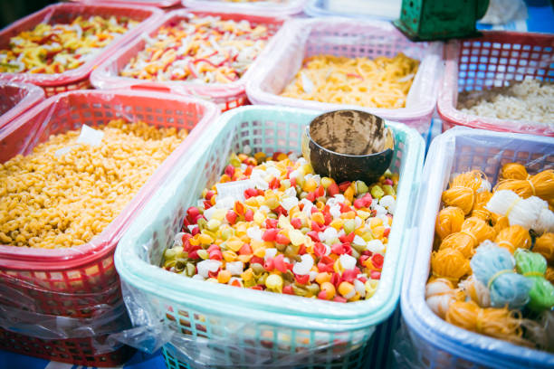 istock Desiccant bags in large plastic baskets with clear liner selling colorful macaroni, pasta, helical corkscrew fusilli, vegetable flat noodle at local market in Can Tho, Vietnam, organic raw vegan 2196741428