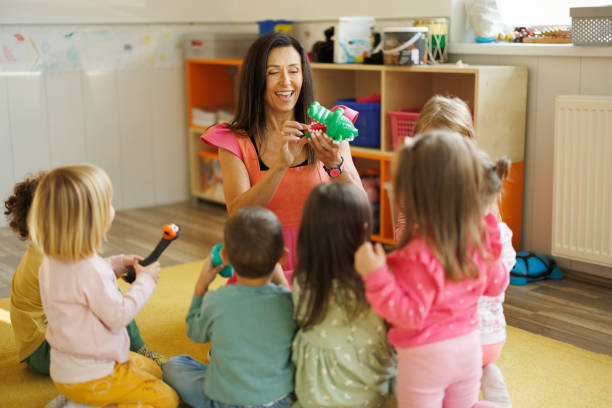 istock Female animator having fun while playing with children in playroom 2196741721