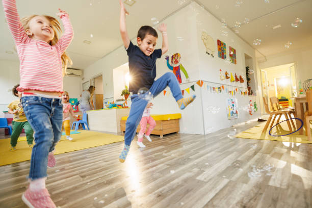 istock Children having fun playing whit soap bubbles in the playroom 2196744563