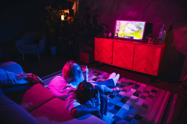 istock Cozy evening family bonding in a brightly lit living room featuring engaging interactions and leisure activities 2196744899