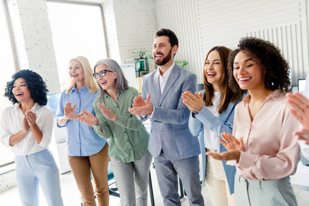 istock Diverse group of colleagues applauding in an office reflecting teamwork and positivity, multi-age 2196745163