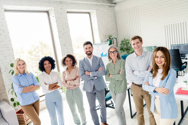 istock Group of professionals working in a stylish office setting with a friendly atmosphere 2196745169