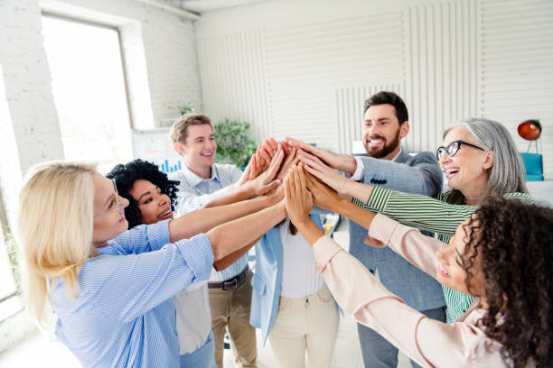 istock Diverse group of professionals uniting hands in a modern office setting to showcase cooperation and teamwork. 2196745175