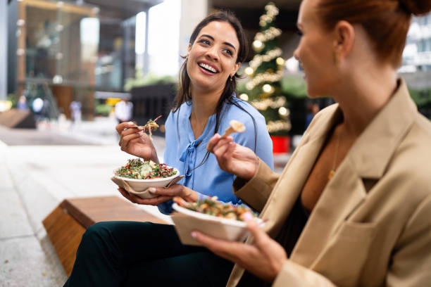 istock Two Women Sharing a Meal Together in a Downtown Christmas Setting 2196747553