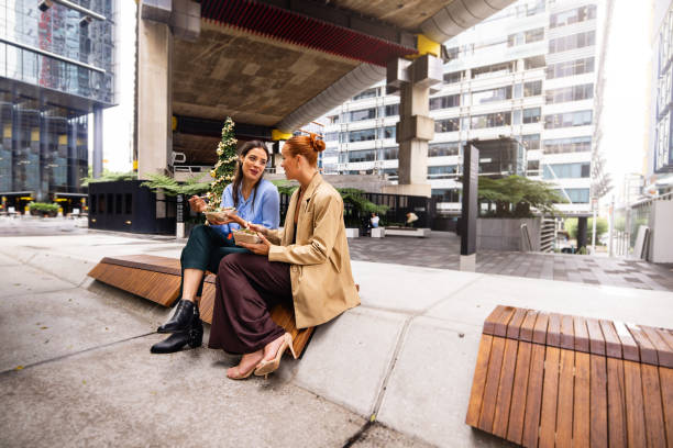 Two Businesswomen Sharing Lunch Outdoors in Sydney Downtown Urban Setting