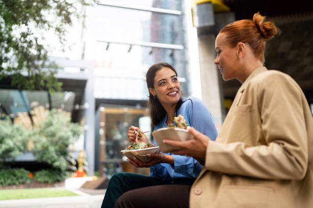 istock Two Professional Women Dining Outdoors in a Downtown Urban Setting 2196749597