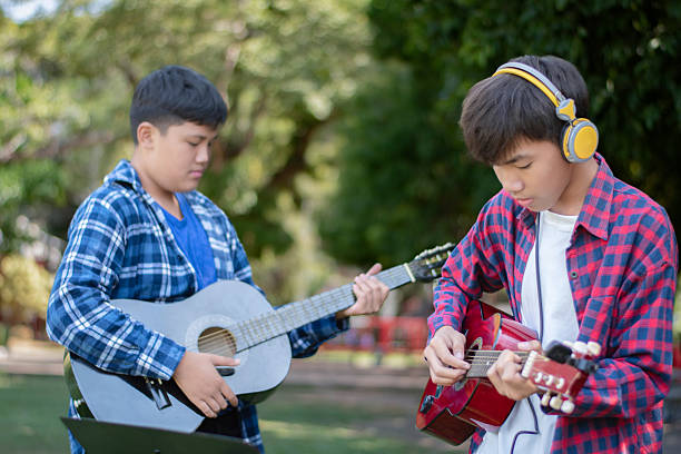 istock Asian teenaged boys with musical instruments. 2196749948