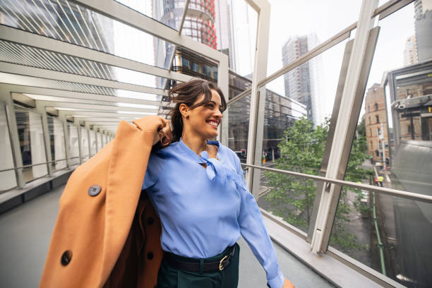 istock Confident Businesswoman Strolling Through Modern Sydney Downtown Footbridge 2196750536