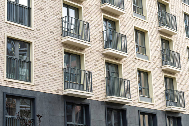 istock Modern apartment building facade with balconies and brick wall exterior 2196750817