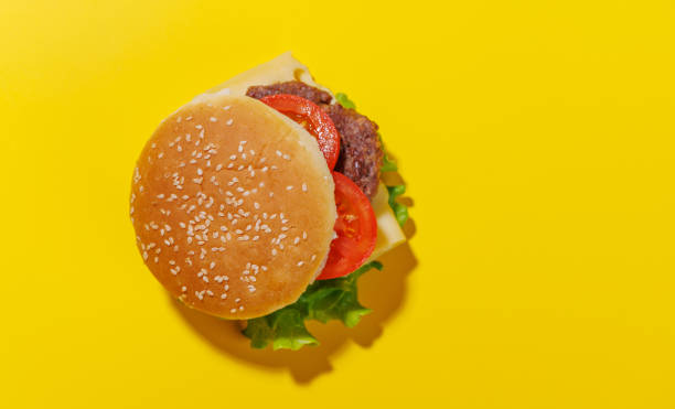 istock Hamburger spread evenly across a bright yellow background 2196750946