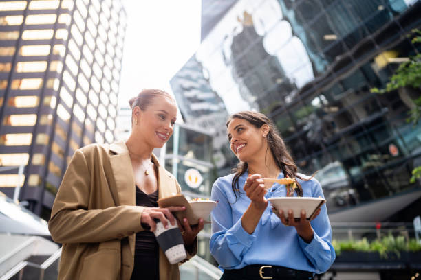 istock Two Professionals Enjoying Lunch Together in a Modern City Setting 2196751055
