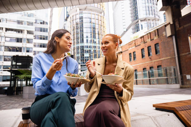 istock Two Businesswomen Sharing Take Out Lunch in a Downtown Urban Setting 2196751975