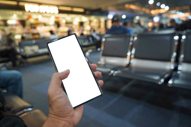 istock hand holding mobile phone showing white blank screen in the airport terminal 2196756798