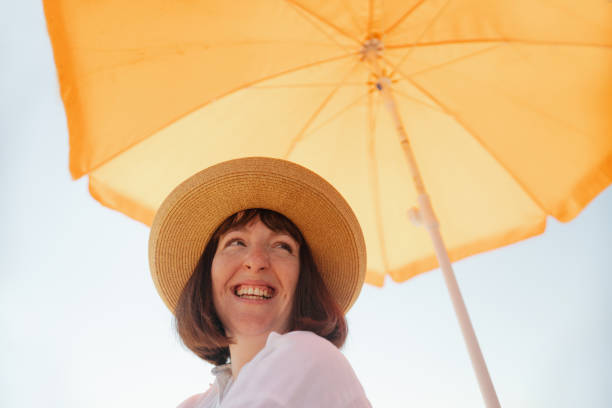 istock Smiling woman at the beach 2196756927