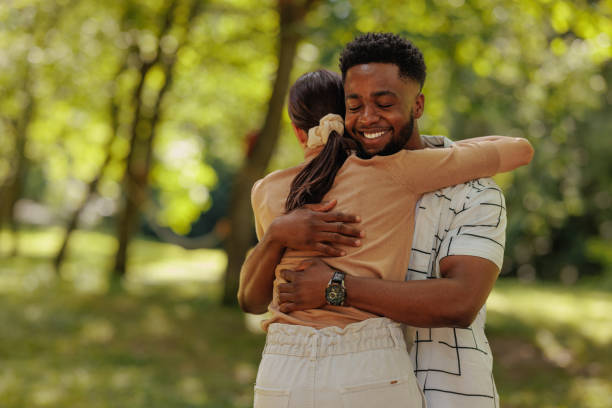 istock Boyfriend hugging his girlfriend in a park 2196757086