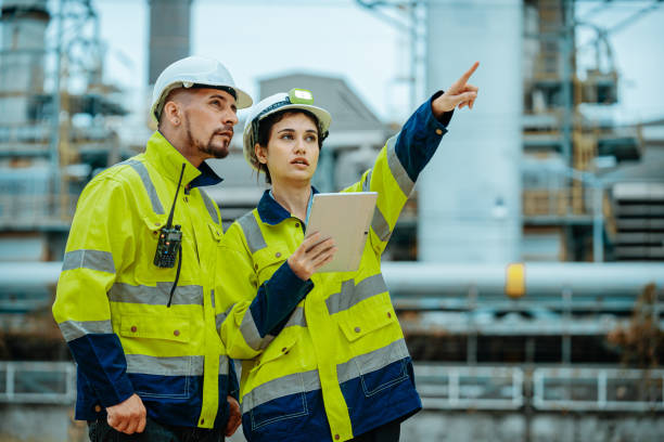istock Workers discuss project details while inspecting an industrial site in daylight 2196758952