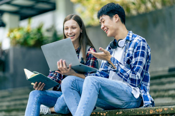 istock Male and female university students work outdoors using laptops and tablets together to discuss technology learning concepts. 2196759756