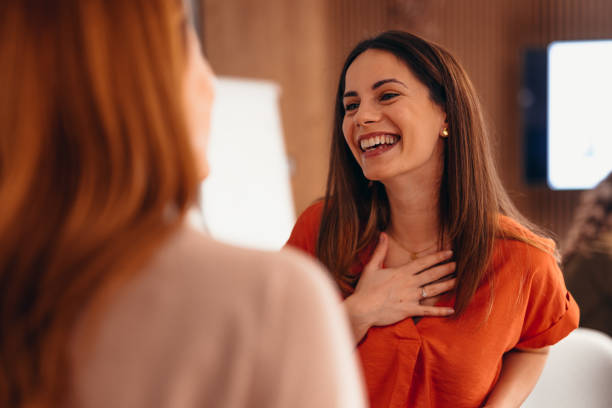 istock Businesswoman laughing and talking with a colleague during a work break 2196760330