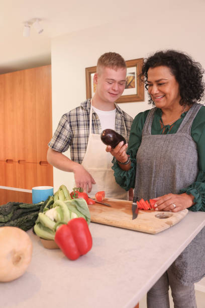 istock Mother cooking with adult son 2196762580