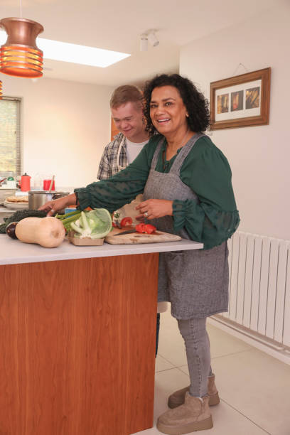 istock Mother cooking with adult son 2196762609