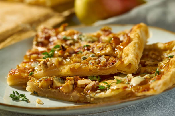 istock Two pieces of pear and blue cheese galette on plate 2196762632