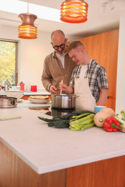 istock Father cooking with adult son 2196762657