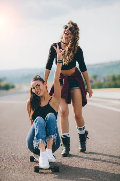 istock Two Friends Enjoy Skateboarding in a Scenic Outdoor Setting 2196764346