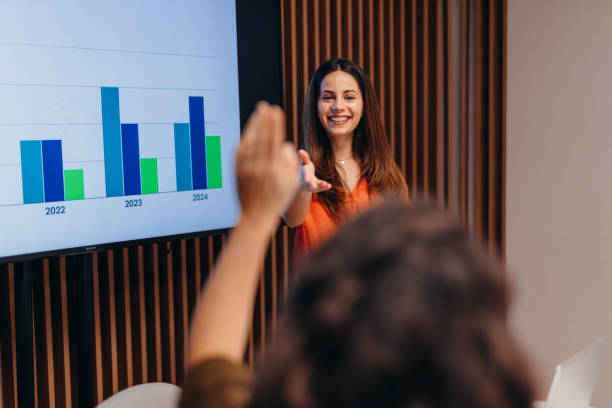 istock Businesswoman leading a presentation showing positive growth on a graph projected on a screen 2196764436
