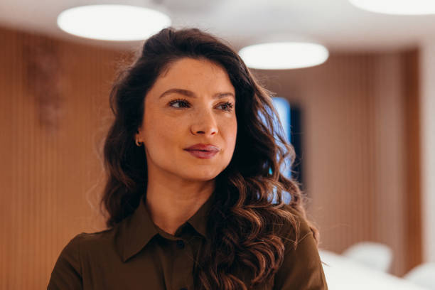 istock Confident businesswoman looking away in modern office space 2196764642
