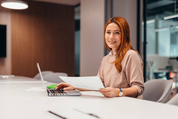 istock Focused businesswoman working on laptop in modern office 2196764664